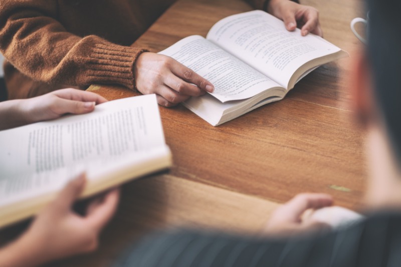 Two people reading at a table